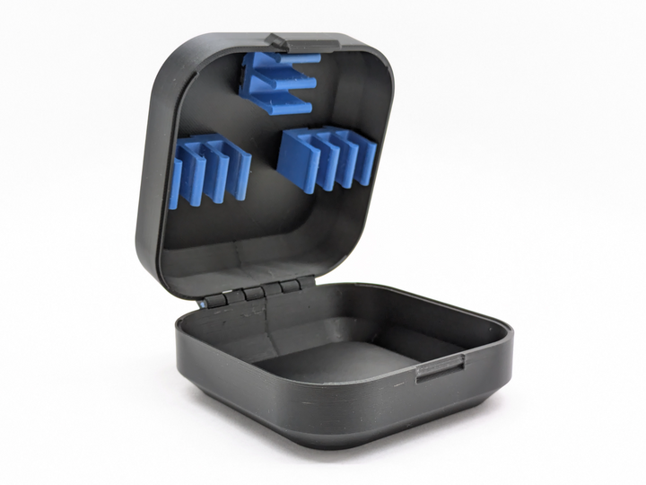 Open 3D printed case for the BetaFPV Air65 with printed battery clips in the lid