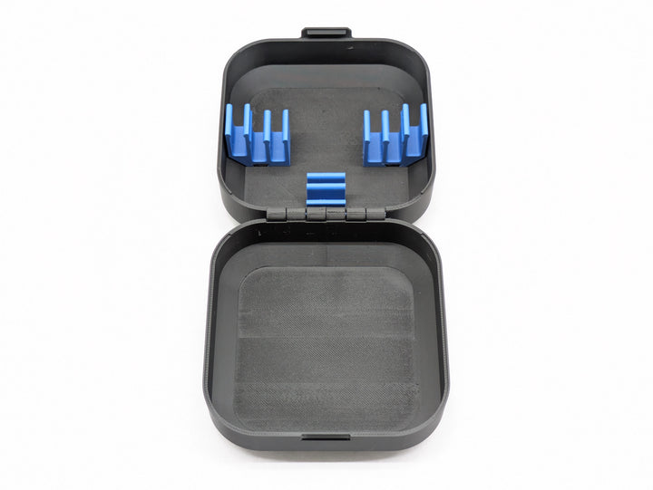 Top-down view of the open case, blue battery clips in one half and the printed hinge across the middle