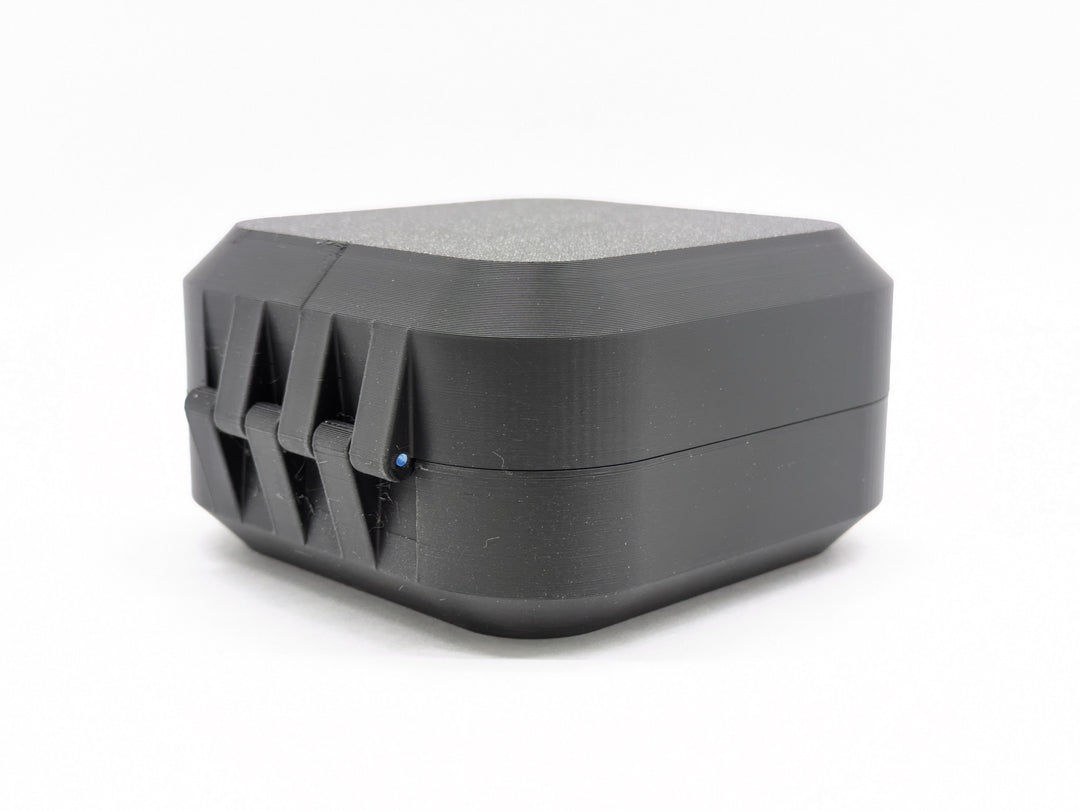 The closed case from the hinge side, showing the printed hinge and the filament pin through it