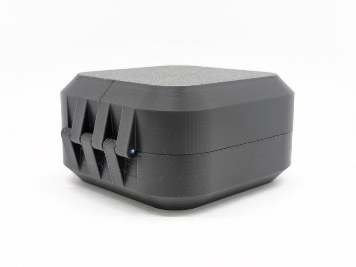 The closed case from the hinge side, showing the printed hinge and the filament pin through it