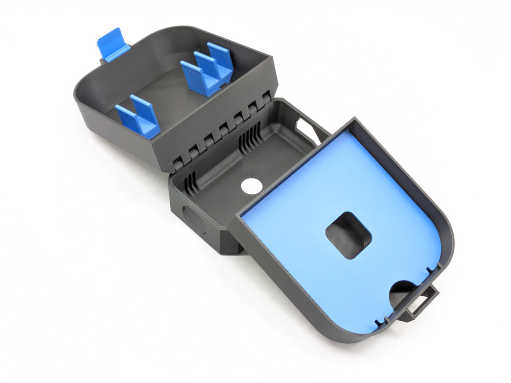 Open charger-version case, black with blue battery clips and a blue shelf