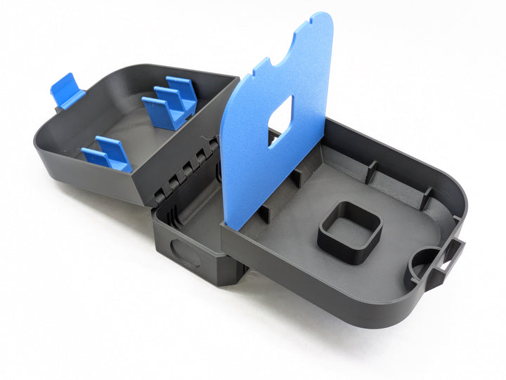 Open charger-version case with the blue shelf lifted, showing the space underneath