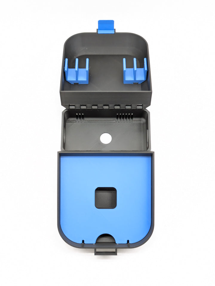 Top-down view of the open charger-version case, black with blue clips and shelf
