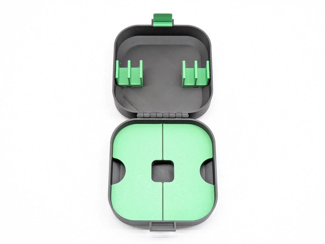 Top-down view of the open case without the charger holder, black with green clips and shelf