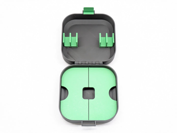 Top-down view of the open case without the charger holder, black with green clips and shelf