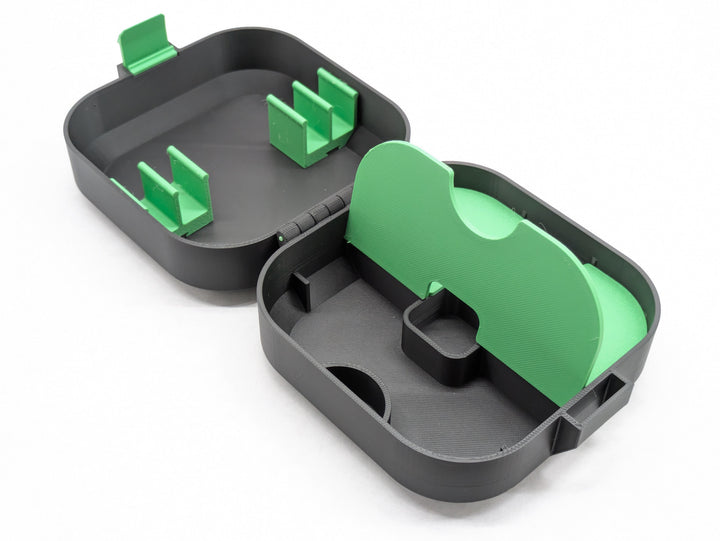 Open case without the charger holder, green shelf lifted to show the space underneath