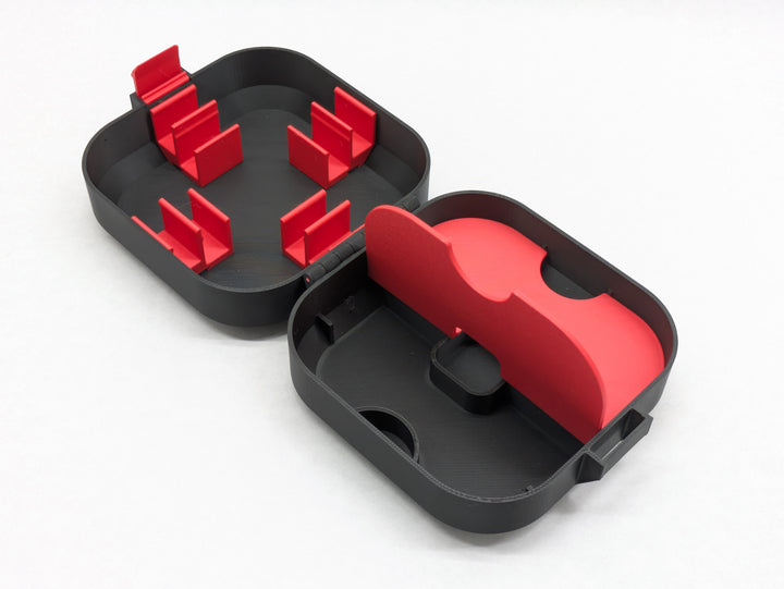 Open Elite case with one red storage lid flipped up, showing the compartment underneath