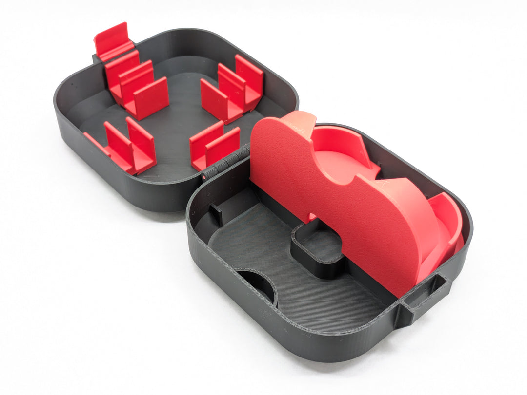 Open black Mobula8 Freestyle case with one half of the red insert lifted, showing the space underneath