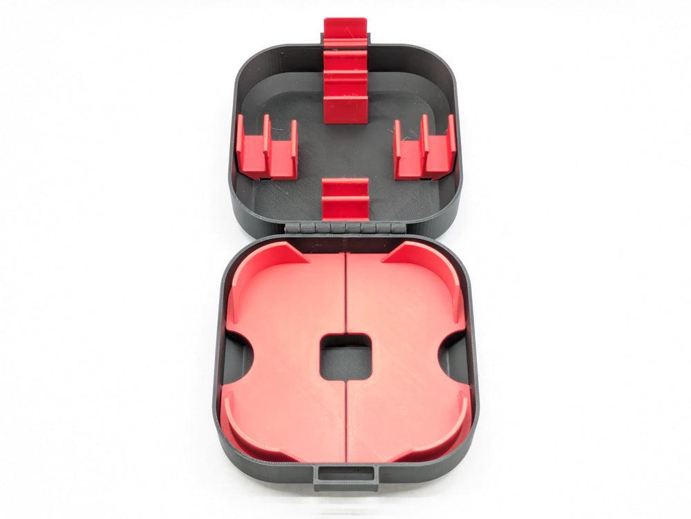 Top-down view of the open black Mobula8 Freestyle case with red battery clips in the lid and a red two-piece insert
