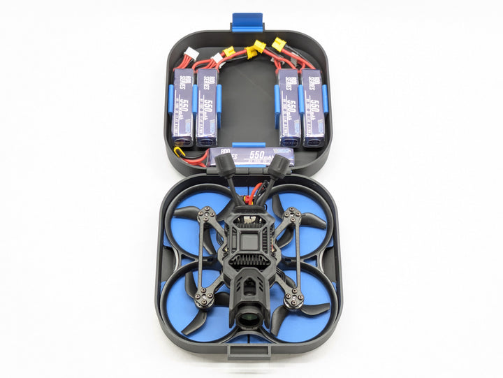 BetaFPV Pavo20 Pro II seated props-on in its printed case beside a full row of 550mAh batteries