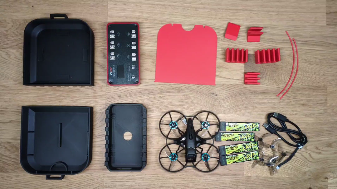 Hands opening the 3D printed Meteor75 Pro and Whoopstor V3 case, showing the drone bay, the charger, and the battery tray