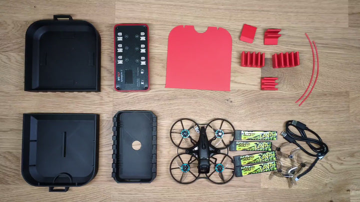 Hands opening the 3D printed Meteor75 Pro and Whoopstor V3 case, showing the drone bay, the charger, and the battery tray